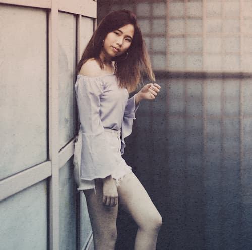 Woman standing against a door looking at camera